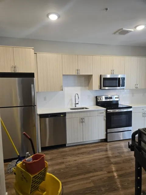 Short-term rental kitchen with stainless appliances after turnover cleaning in New Jersey