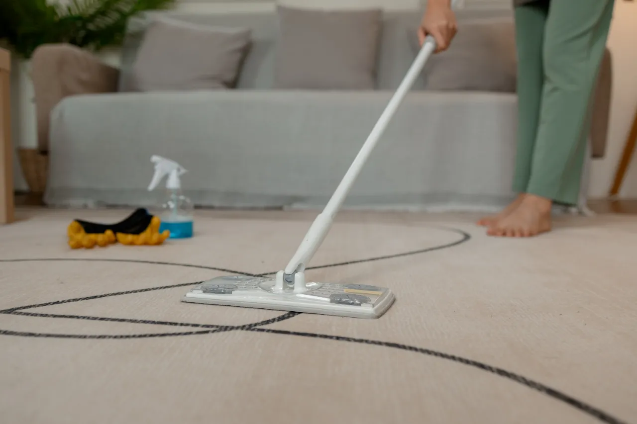 Airbnb cleaning crew mopping a rental living room in New Jersey