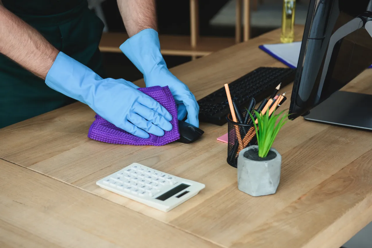 Desktop computer and keyboard disinfected during office cleaning in New Jersey
